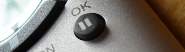 Close up of a pause button on a remote control